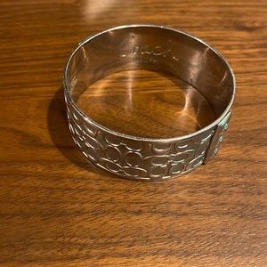 Gentle worn Coach bangle.